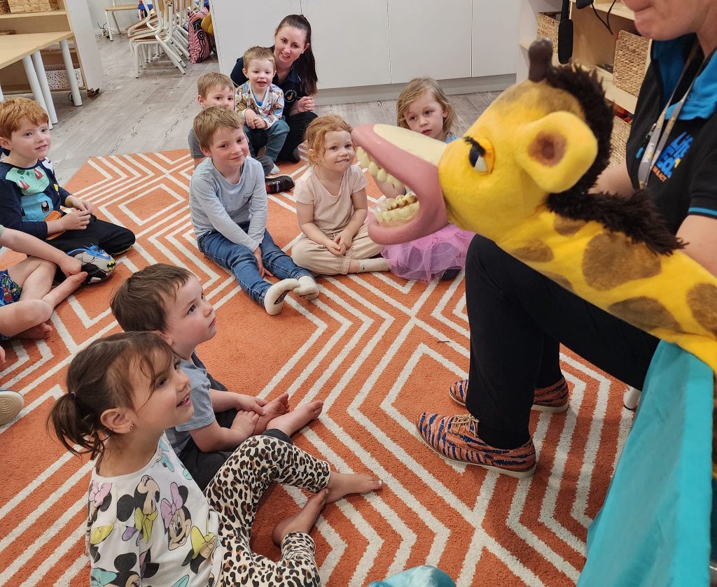 Children listening to a story on an indoor playmat