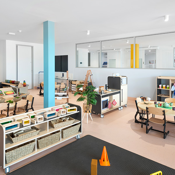 Shelves of games and a table for activities at our Gateshead childcare centre