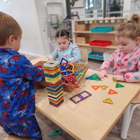 Children playing at a table in our Eglinton childcare centre