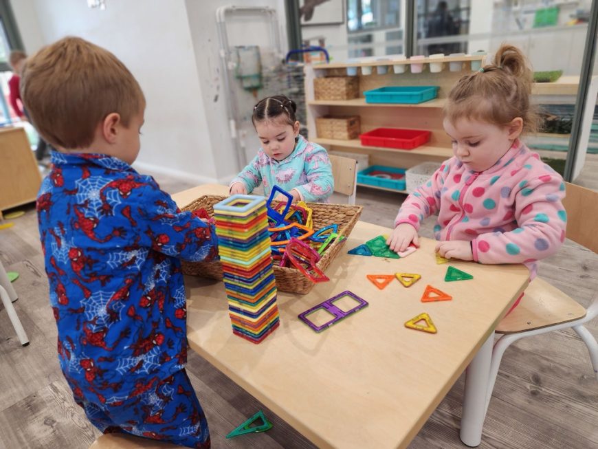Children playing at a table in our Eglinton childcare centre