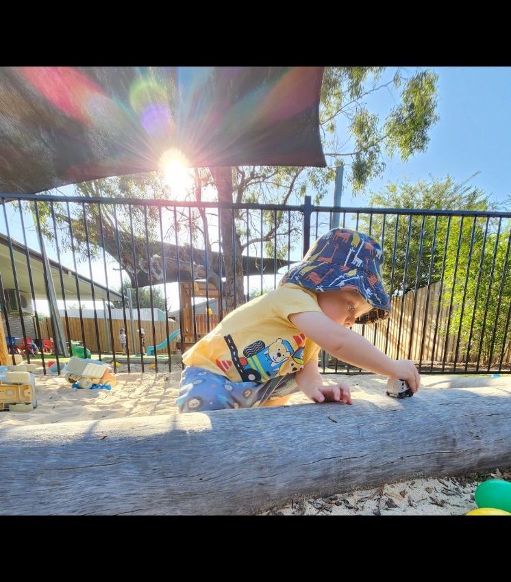 A child playing outside on a tree in Eglinton